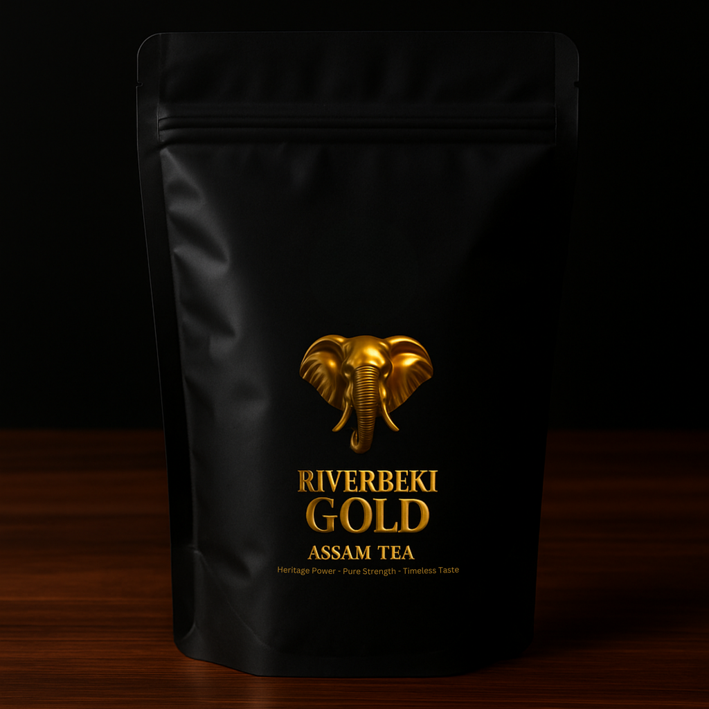 Black tea packaging with gold elephant logo and text on a dark background featuring "Riverbeki Gold" export grade Assam CTC tea