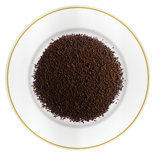 Close-up of Riverbeki Classic Assam Premium CTC Tea loose granules displayed on a white plate with gold rim, highlighting the bold rich CTC texture